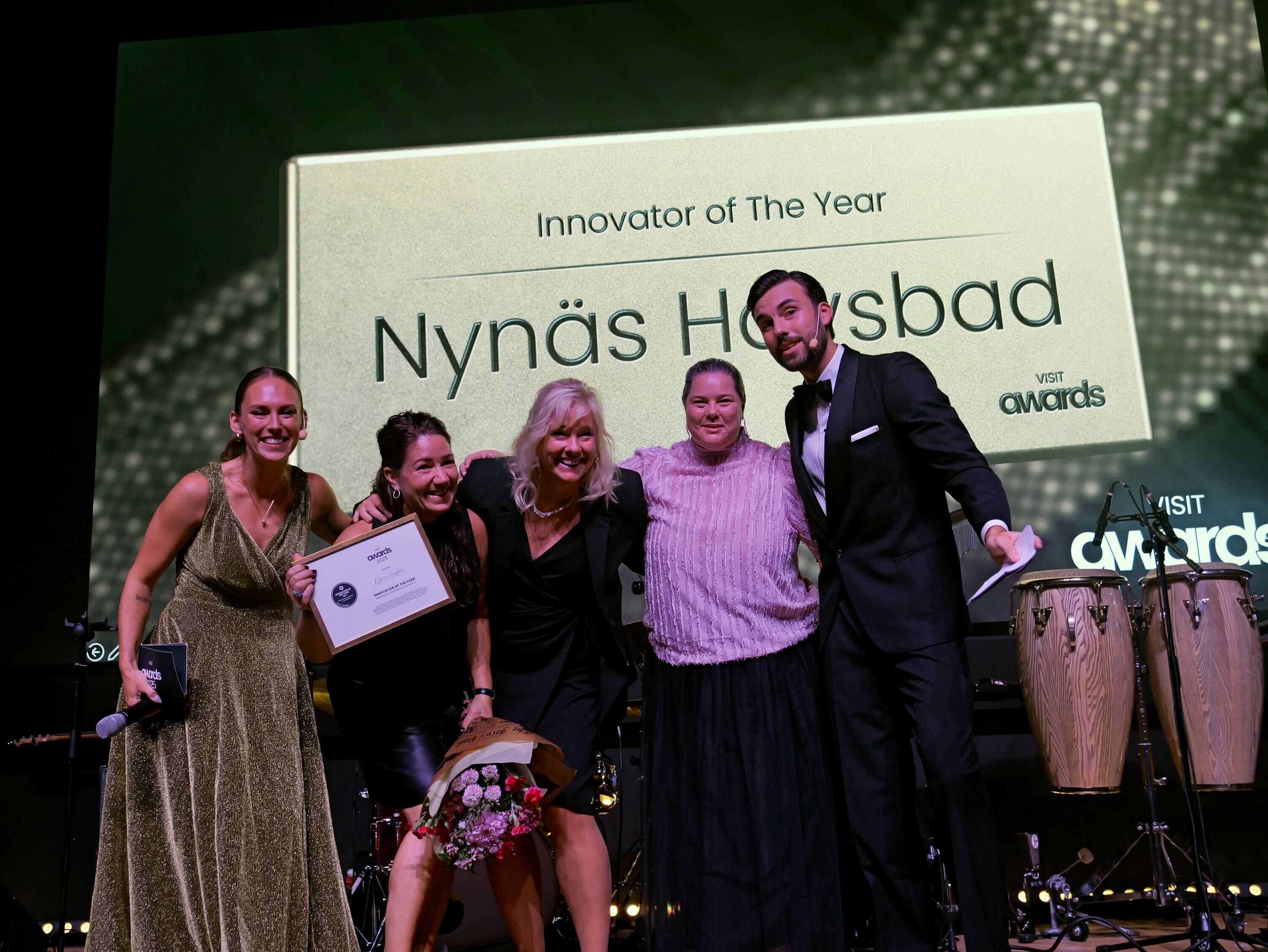 Visit Awards winners on stage happy with flowers 