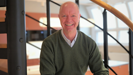 Richard Wiegmann sitting in the stairs at the office.
