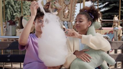 Eating cotton candy at an amusement park