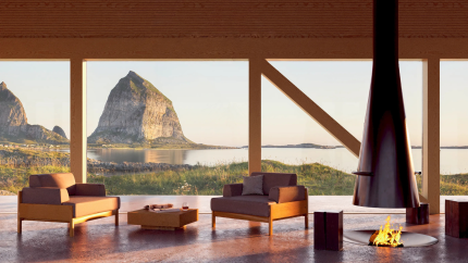 Modern lounge with two armchairs and a suspended fireplace, facing a calm bay and a steep mountain at sunset.