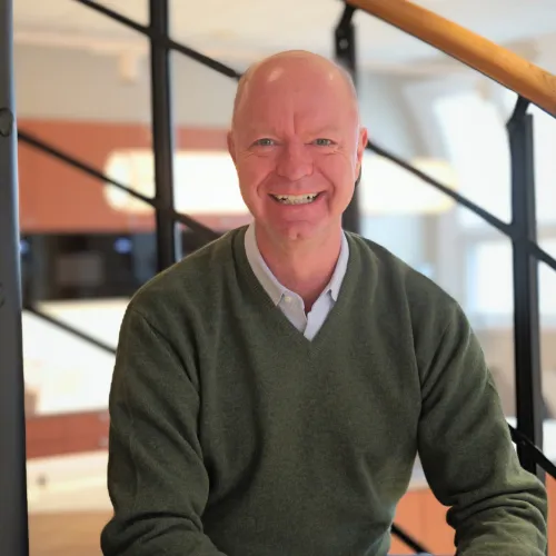 Richard Wiegmann sitting in the stairs at the office.